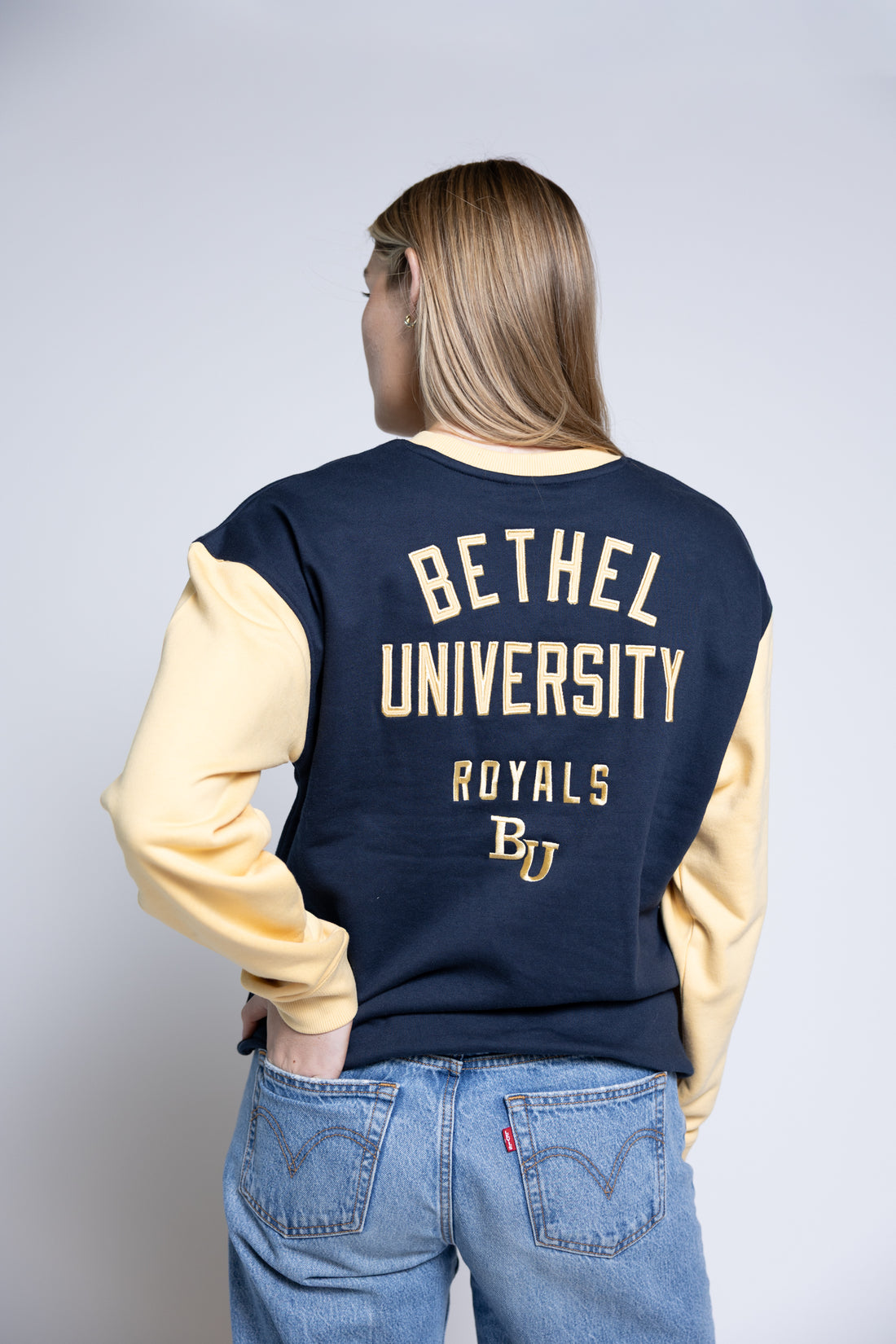 Person wearing a navy and yellow &