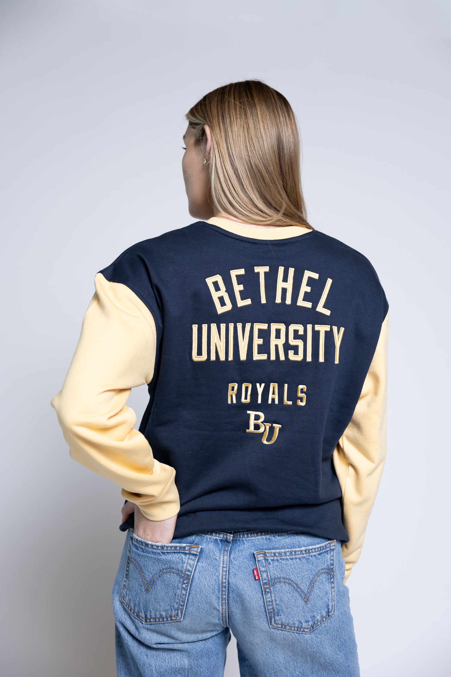 Person wearing a navy and yellow &